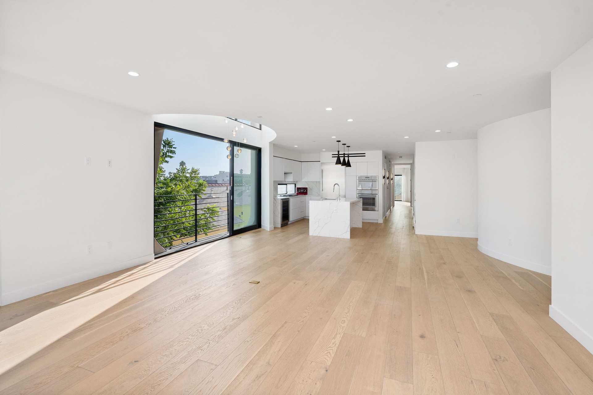 Spacious living room with hardwood floors and glass doors opening to the yard. California, USA